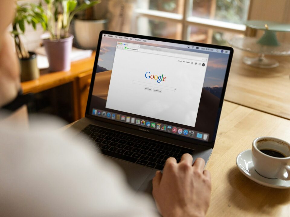 person using macbook pro on table